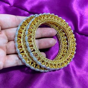 Cubic zirconia bangles with gold plating.